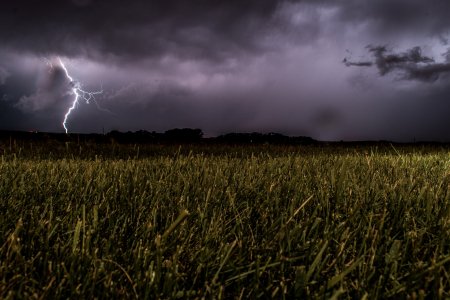 Lighting over grassy field
